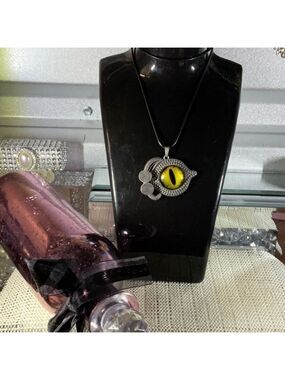 YELLOW EVIL EYE PENDENT ON AN 18” TO 20” BLACK LEATHER NECKLACE